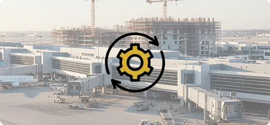 An aerial photo of ongoing construction at Los Angeles International Airport (LAX), showing the new people mover station under construction, with a gear icon overlaying the image.