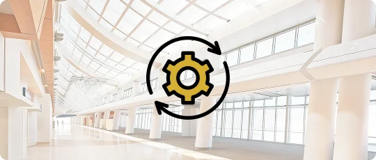 A foggy bright image of an airport terminal's inside view with round arrows and a wheel icon visible on them.