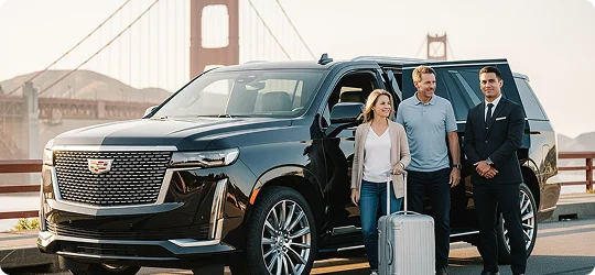 A chauffeur in a suit stands next to a black Cadillac Escalade SUV with the rear door open for a couple who have just exited the vehicle, holding a silver suitcase. The Golden Gate Bridge is visible in the background.