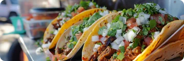The Mission: Close-up of colorful street tacos stacked with fresh toppings.