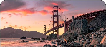 A beautiful sunset illuminated view of the Golden Gate Bridge in San Francisco from the lower left angle.